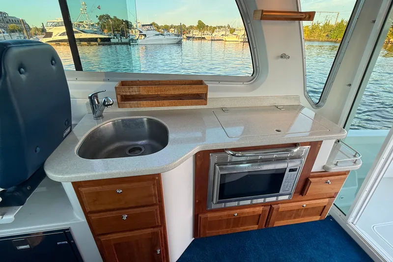 Slide: The Image of Interior of 2016 Back Cove 34 boat with kitchenette, sink, and microwave. - 15
