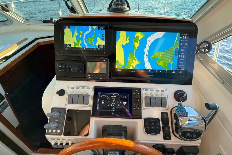 Slide: The Image of Helm of 2016 Back Cove 34 boat with navigation screens and controls. - 23