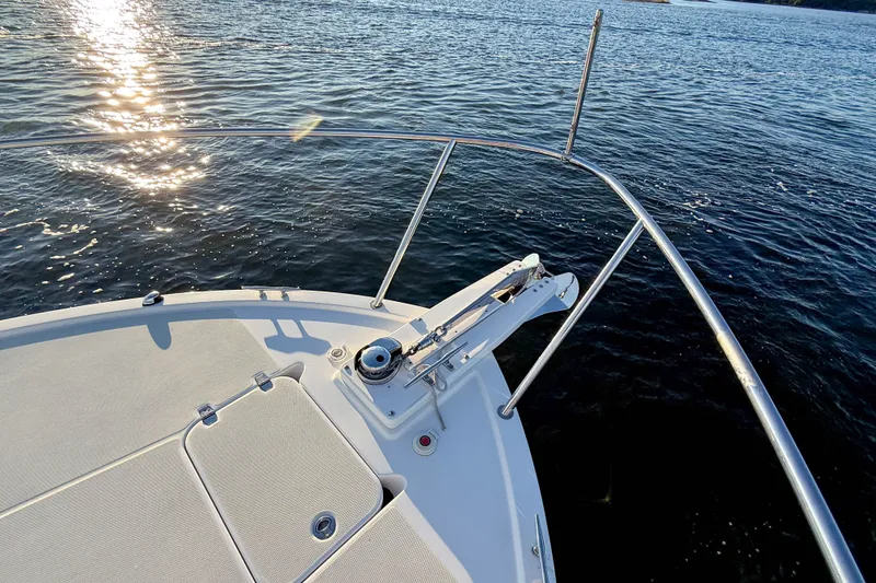 Slide: The Image of Bow of 2016 Back Cove 34 boat with sunlit water view. - 36