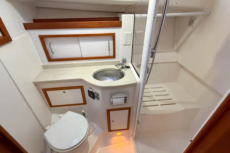 Slide: The Image of 2016 Back Cove 34 yacht bathroom with sink, toilet, and shower area. - 31