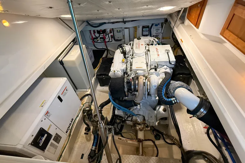 Slide: The Image of Engine room of a 2016 Back Cove 34 boat, featuring a Kohler generator and diesel engine. - 41