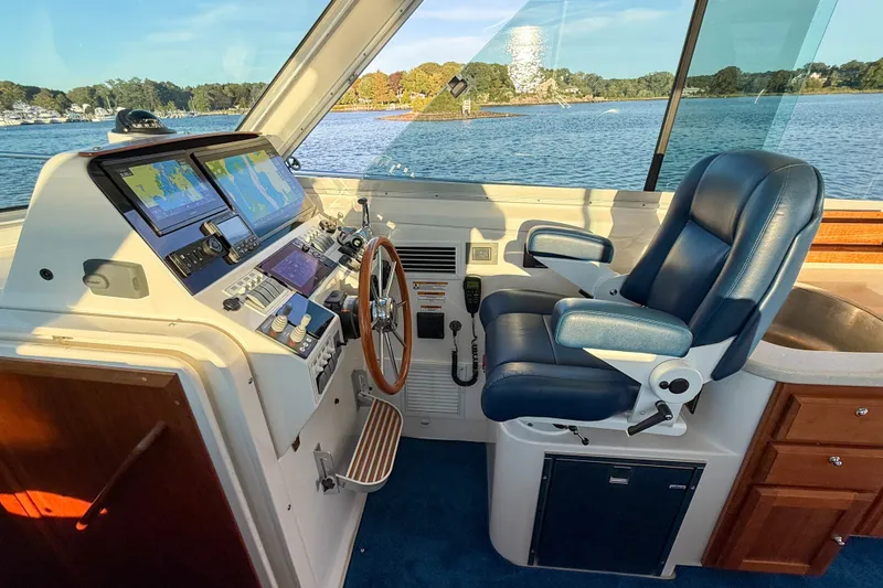 Slide: The Image of Helm of 2016 Back Cove 34 boat with navigation screens and captain's chair. - 19