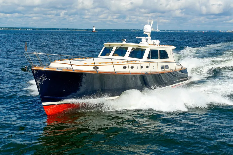 The Image of 2010 Vicem 64 yacht cruising on open water under a cloudy sky. - 0