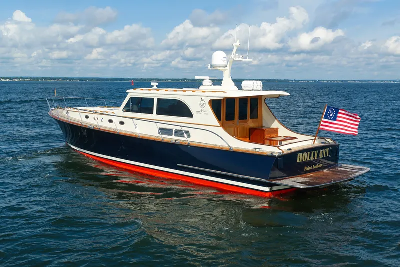Slide: The Image of 2010 Vicem 64 yacht cruising on open water under a partly cloudy sky. - 19