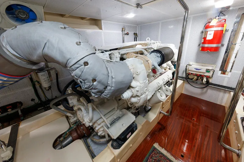 Slide: The Image of Engine room of 2010 Vicem 64 yacht, featuring a well-maintained engine and fire safety equipment. - 93