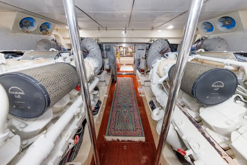 Slide: The Image of Engine room of 2010 Vicem 64 yacht with dual MAN engines and polished flooring. - 99
