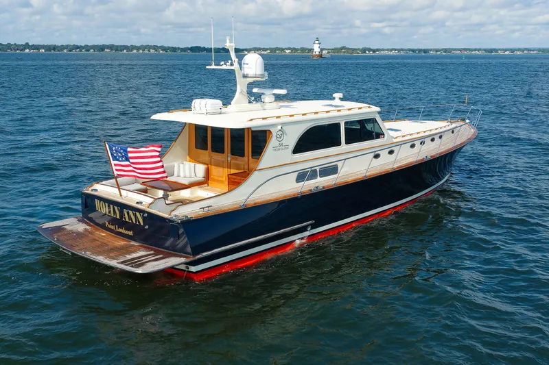 Slide: The Image of 2010 Vicem 64 yacht cruising on open water with American flag displayed. - 17