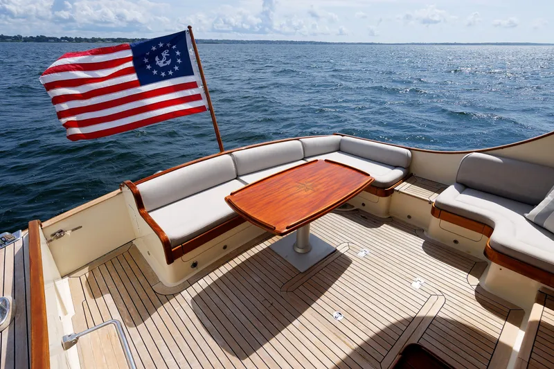 Slide: The Image of Luxurious 2010 Vicem 64 yacht deck with seating, wooden table, and nautical flag. - 32