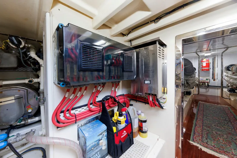 Slide: The Image of Engine room of a 2010 Vicem 64 yacht, featuring electrical panels and maintenance tools. - 102
