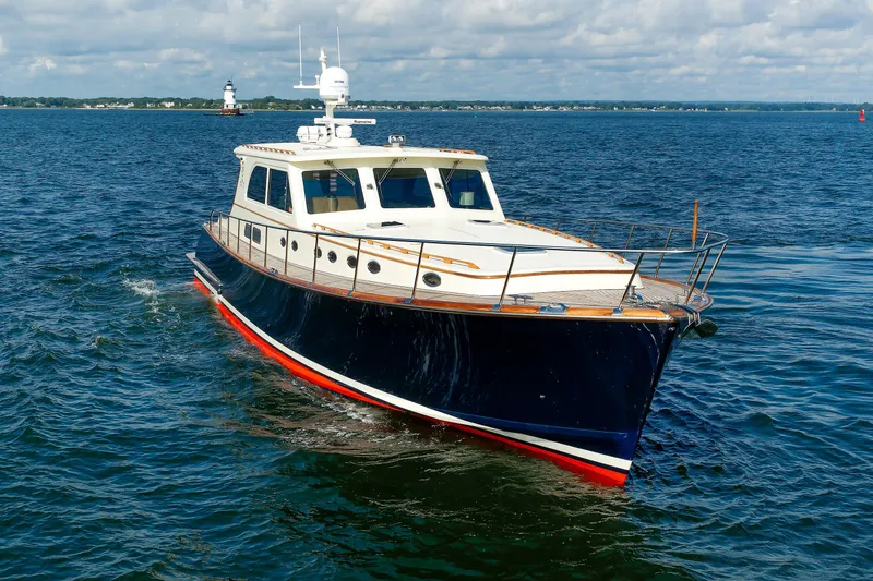 Slide: The Image of 2010 Vicem 64 yacht cruising on open water under a partly cloudy sky. - 22