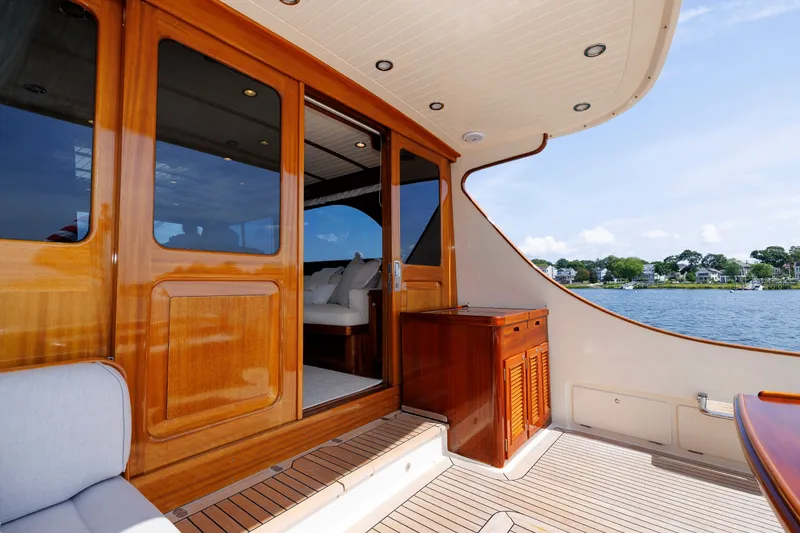 Slide: The Image of Luxurious 2010 Vicem 64 yacht deck with wooden finishes and scenic water view. - 40