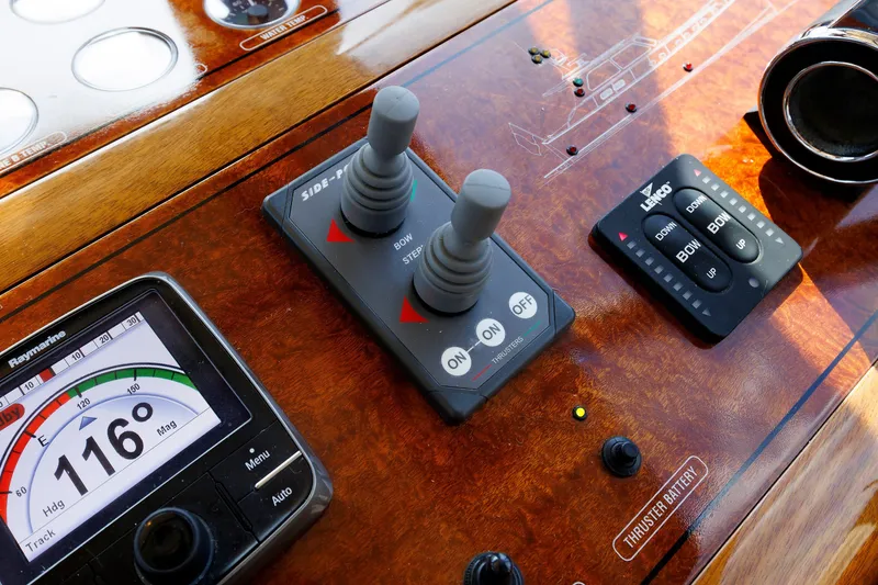 Slide: The Image of Control panel of a 2010 Vicem 64 yacht with navigation and thruster controls. - 64