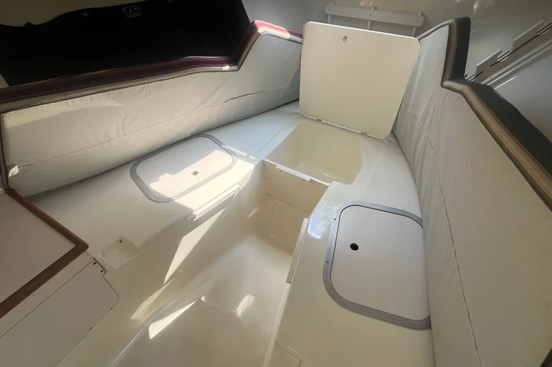Slide: The Image of Interior of a 2004 Pursuit 2670 Denali LS boat, featuring storage compartments. - 15
