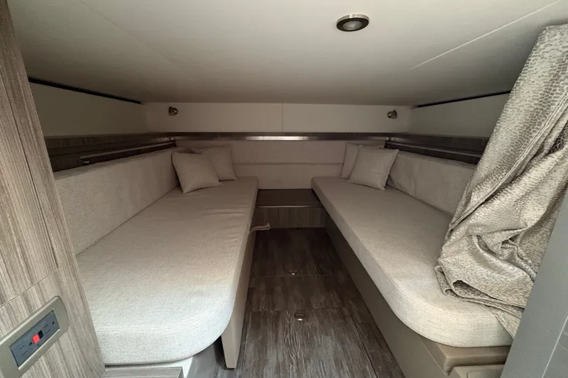 Slide: The Image of 2025 Sea Ray Sundancer 320 cabin interior with twin beds and modern decor. - 29