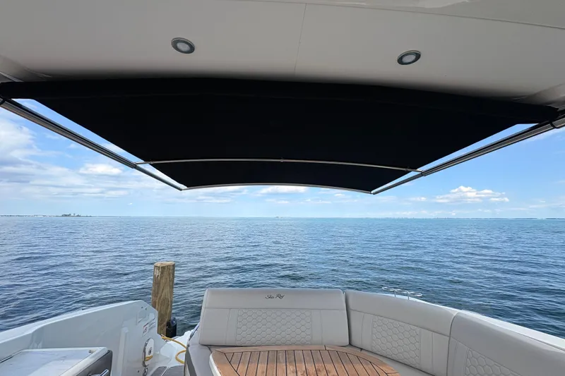 Slide: The Image of 2025 Sea Ray Sundancer 320 yacht with ocean view and retractable canopy. - 36