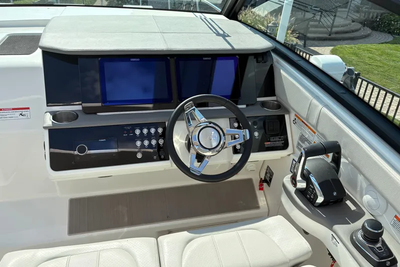Slide: The Image of Helm of 2025 Sea Ray Sundancer 320 with modern controls and dual displays. - 17