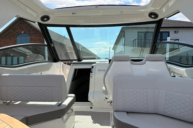 Slide: The Image of Interior view of 2025 Sea Ray Sundancer 320 yacht with modern seating and panoramic windows. - 20