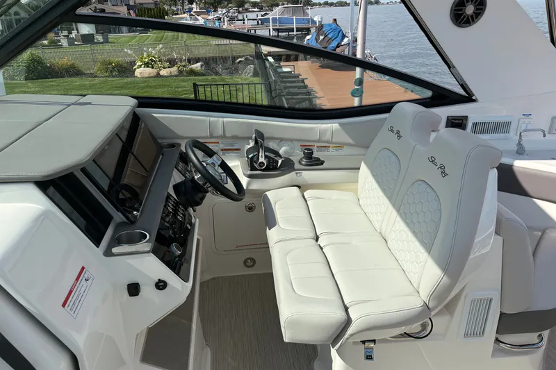 Slide: The Image of 2025 Sea Ray Sundancer 320 cockpit with modern controls and plush seating. - 15