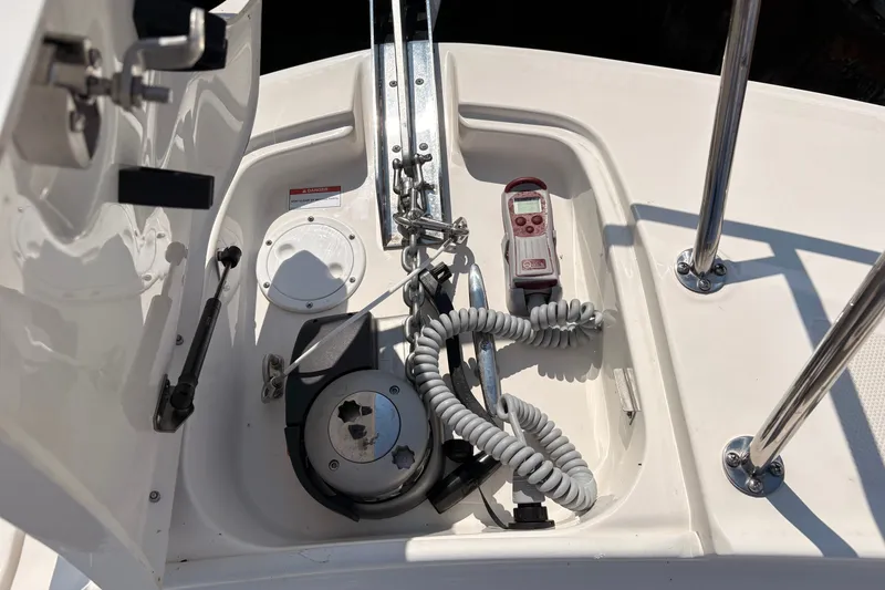 Slide: The Image of Anchor compartment of 2025 Sea Ray Sundancer 320 with winch and control panel. - 22
