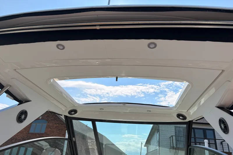 Slide: The Image of 2025 Sea Ray Sundancer 320 yacht interior with sunroof and modern design. - 19
