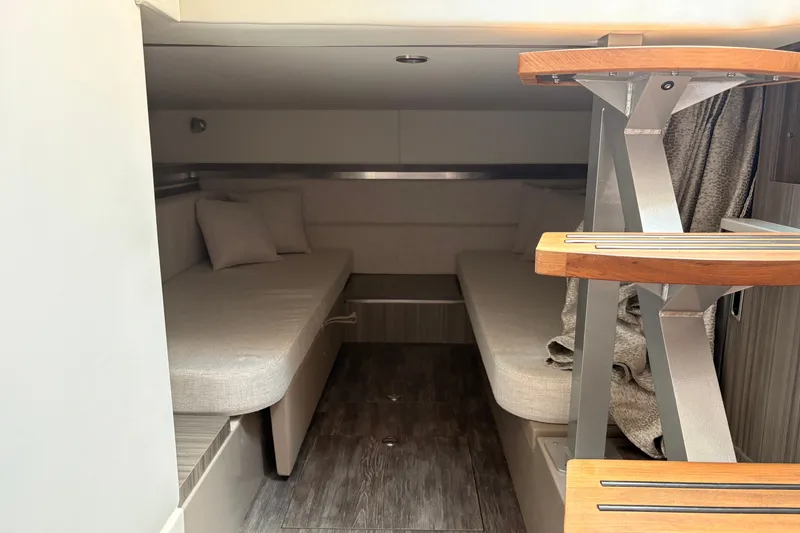 Slide: The Image of Interior cabin of 2025 Sea Ray Sundancer 320 with modern seating and wooden steps. - 28