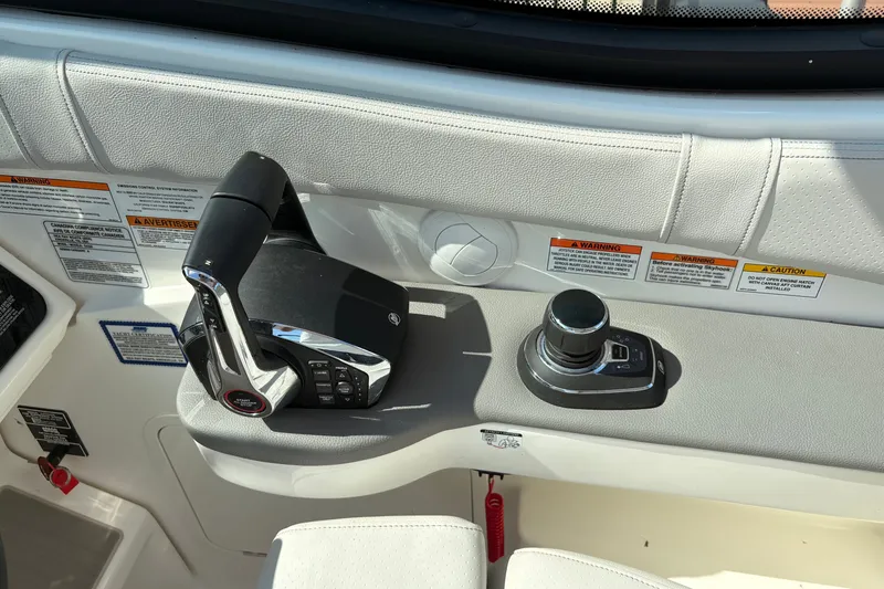 Slide: The Image of Control panel of 2025 Sea Ray Sundancer 320 boat with throttle and joystick. - 16