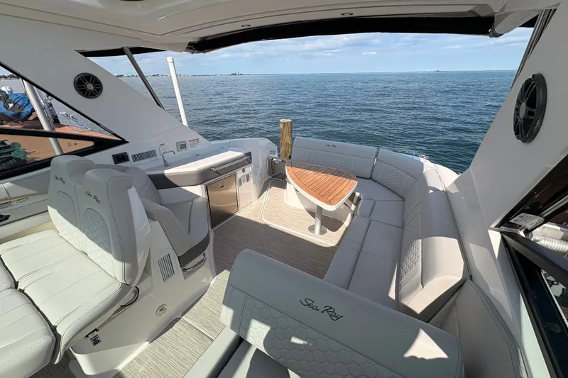 Slide: The Image of Luxurious 2025 Sea Ray Sundancer 320 yacht interior with ocean view and elegant seating. - 14