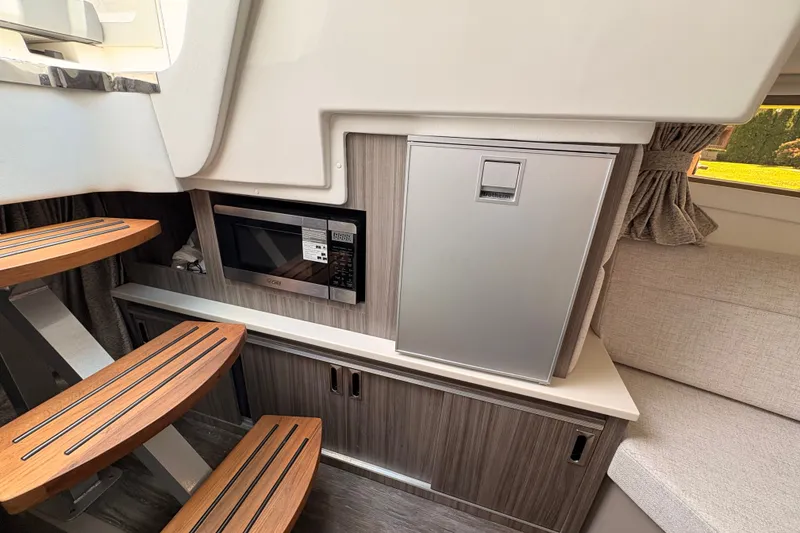 Slide: The Image of Interior of 2025 Sea Ray Sundancer 320 with microwave and compact fridge. - 30