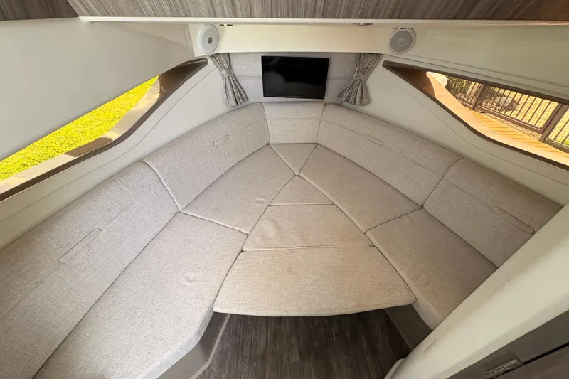 Slide: The Image of Interior of 2025 Sea Ray Sundancer 320, featuring a cozy, modern seating area. - 26