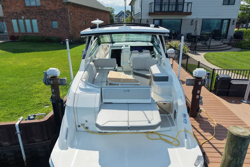 Slide: The Image of 2025 Sea Ray Sundancer 320 docked, showcasing spacious deck and modern design. - 7