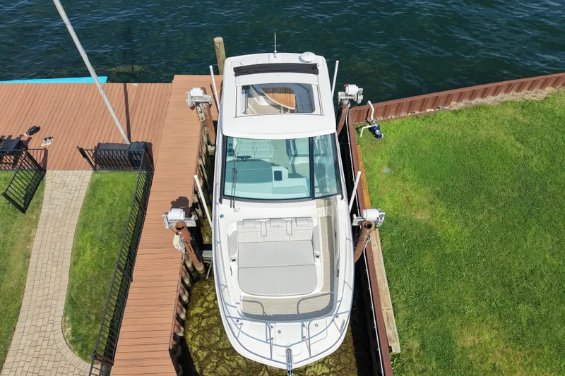 Slide: The Image of 2025 Sea Ray Sundancer 320 docked by a wooden pier, aerial view. - 9