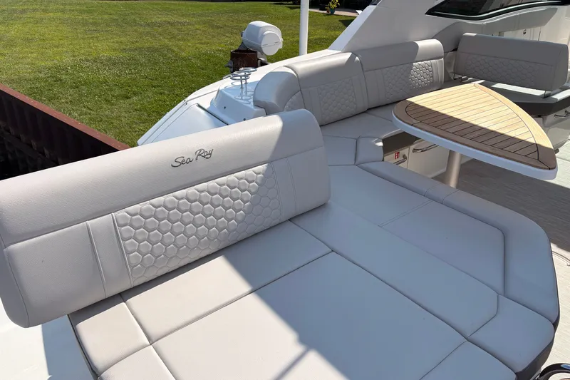 Slide: The Image of Luxurious seating on 2025 Sea Ray Sundancer 320 yacht with elegant design and wooden table. - 11