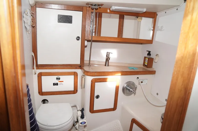 Slide: The Image of Bathroom interior of 2000 Catalina 36 MkII sailboat with wooden cabinets and fixtures. - 33