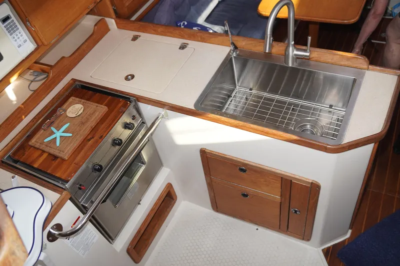 Slide: The Image of Galley kitchen in 2000 Catalina 36 MkII sailboat with stove and stainless steel sink. - 21