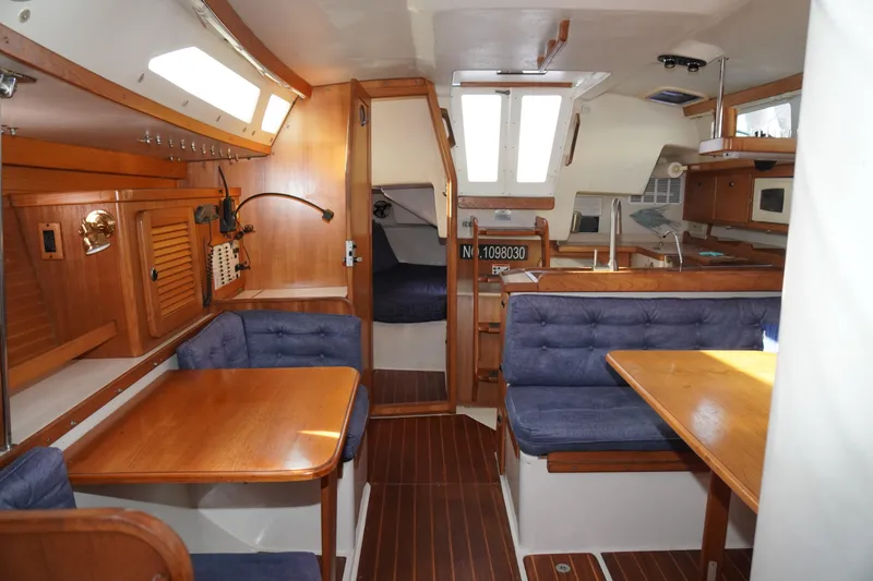 Slide: The Image of Interior of 2000 Catalina 36 MkII sailboat with wood finish and blue seating. - 30