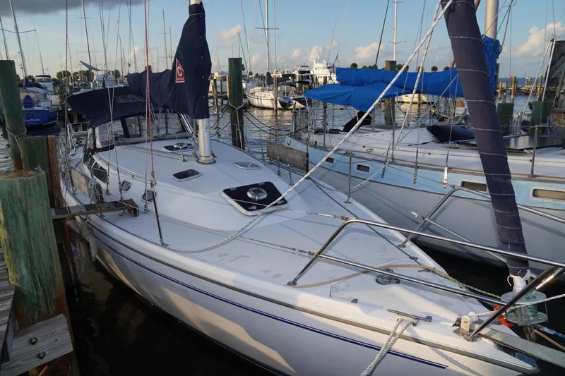 Slide: The Image of 2000 Catalina 36 MkII sailboat docked at marina, surrounded by other boats. - 2