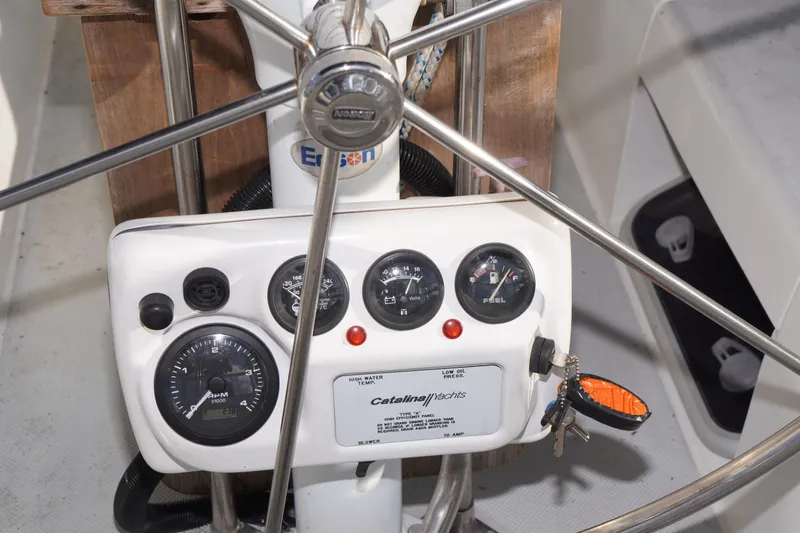 Slide: The Image of Control panel of a 2000 Catalina 36 MkII sailboat with gauges and keys. - 11
