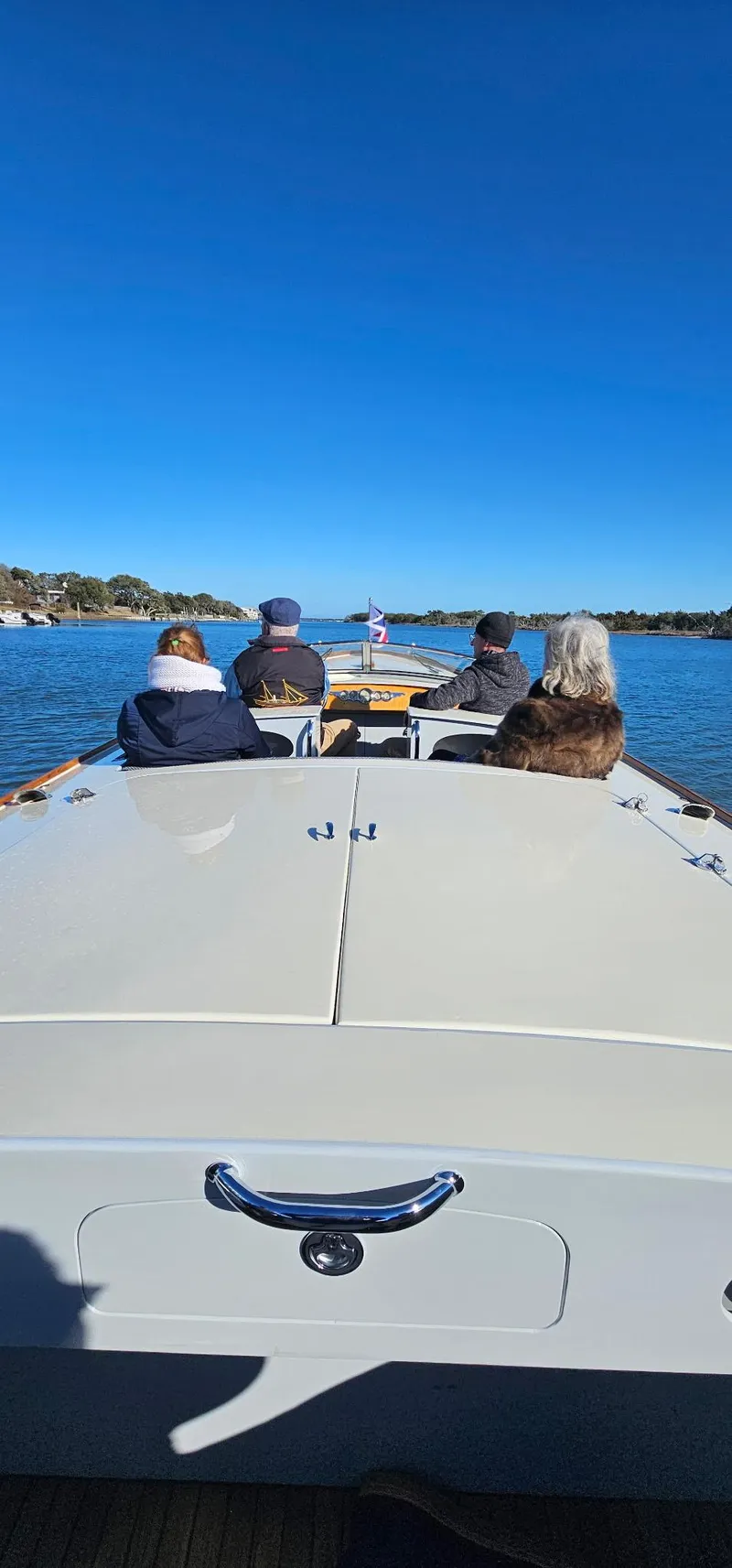 Slide: The Image of People enjoying a ride on a Custom M27 boat, 2023 model, under clear blue skies. - 24