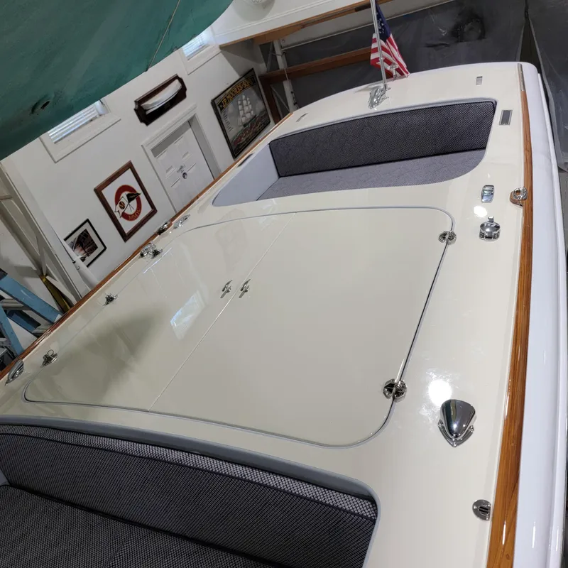 Slide: The Image of Custom M27 boat interior with sleek design, featuring cushioned seating and polished hardware, 2023 model. - 13