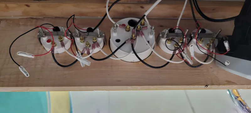 Slide: The Image of Electrical wiring setup with multiple connections on a wooden board, Custom M27, 2023. - 23