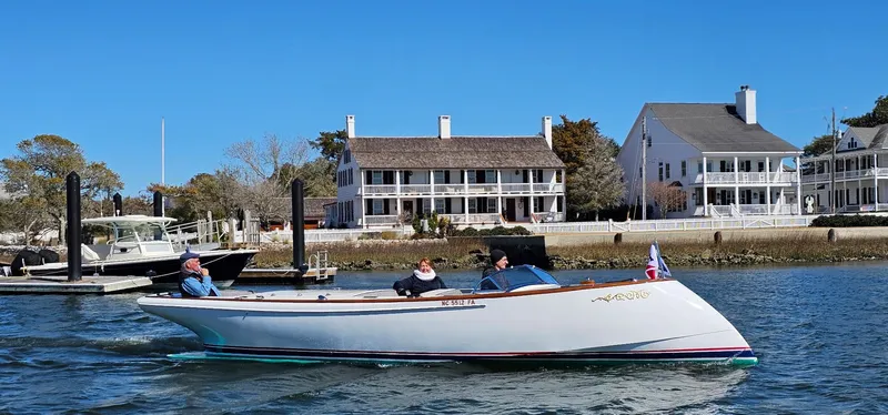Slide: The Image of Custom M27 boat cruising near waterfront homes, 2023 model. - 33