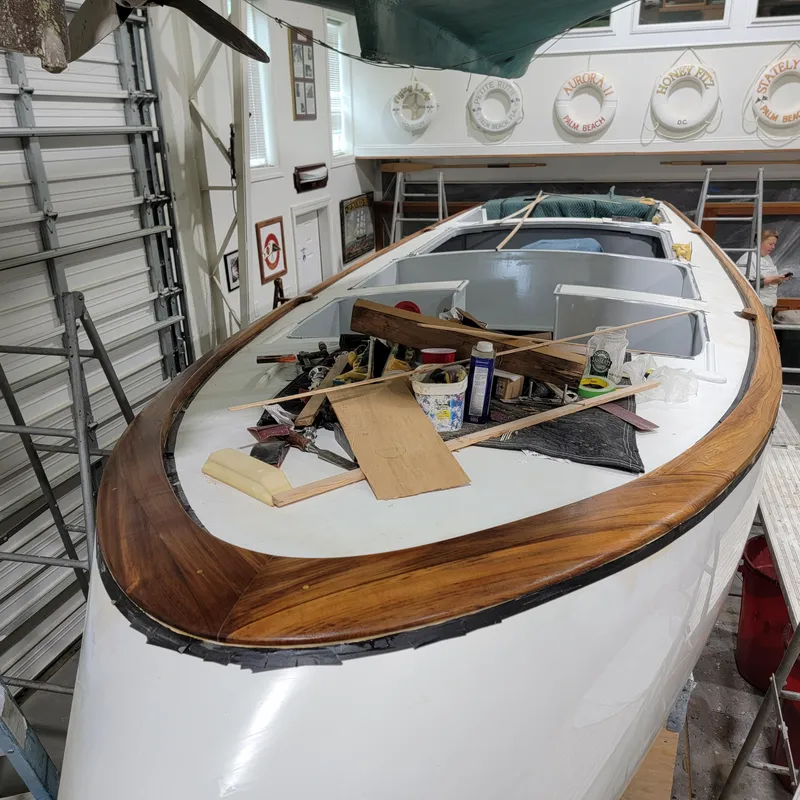 Slide: The Image of Custom M27 boat under construction in a workshop, surrounded by tools and materials. - 18