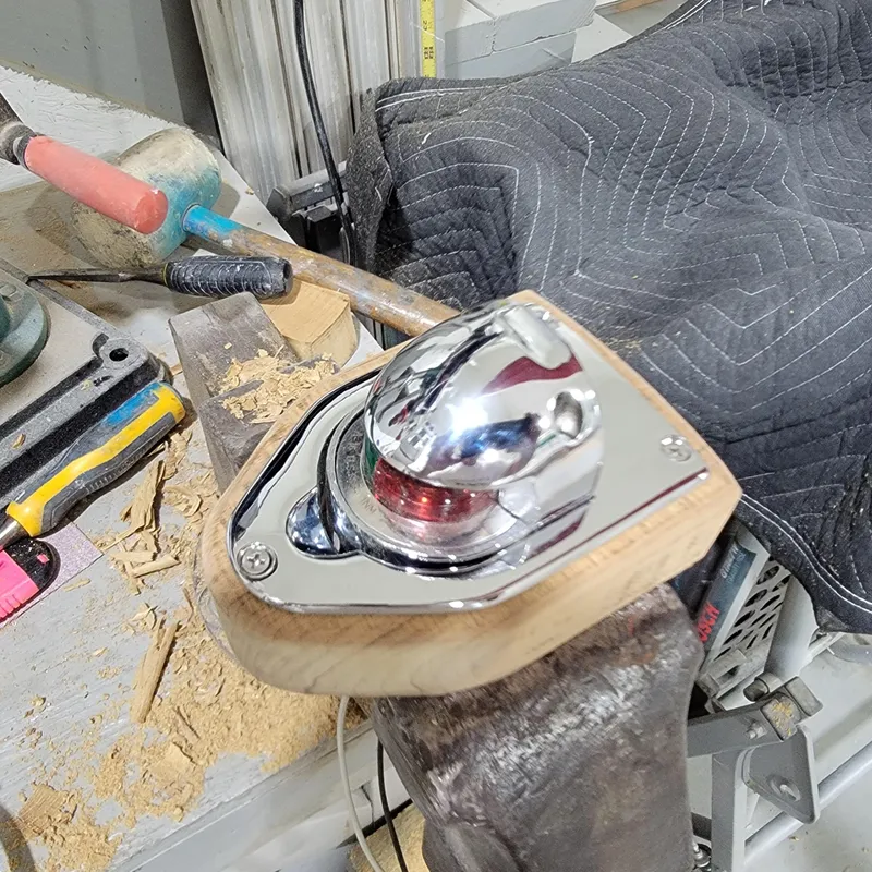 Slide: The Image of Custom M27 device on workbench with tools and wood shavings, 2023. - 20