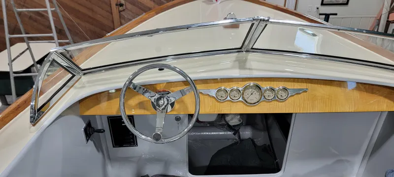 Slide: The Image of Vintage-style boat dashboard with wooden accents, chrome steering wheel, and classic gauges, Custom M27, 2023. - 22
