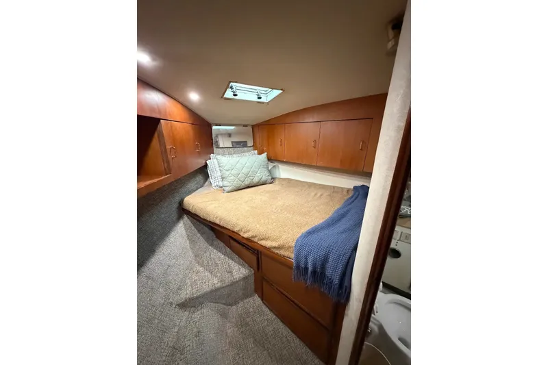 Slide: The Image of Cozy cabin interior of 1997 Ocean Yachts 40 Super Sport with bed and storage cabinets. - 62