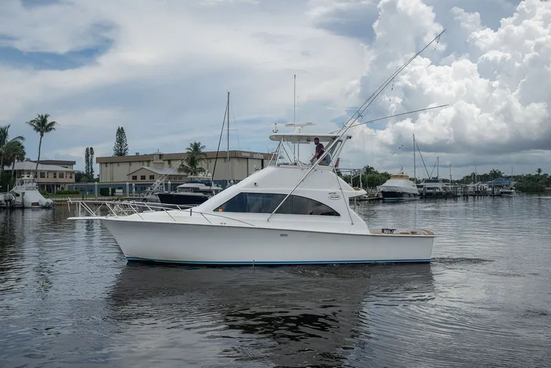 Slide: The Image of 1997 Ocean Yachts 40 Super Sport cruising in a marina under cloudy skies. - 2