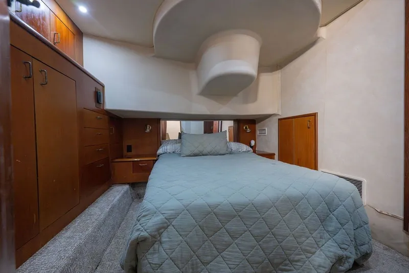 Slide: The Image of Cozy bedroom interior of 1997 Ocean Yachts 40 Super Sport with wood cabinetry and soft lighting. - 66