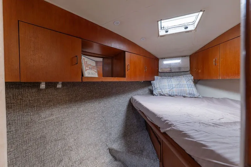 Slide: The Image of Cozy cabin interior of 1997 Ocean Yachts 40 Super Sport with wooden cabinets and skylight. - 64