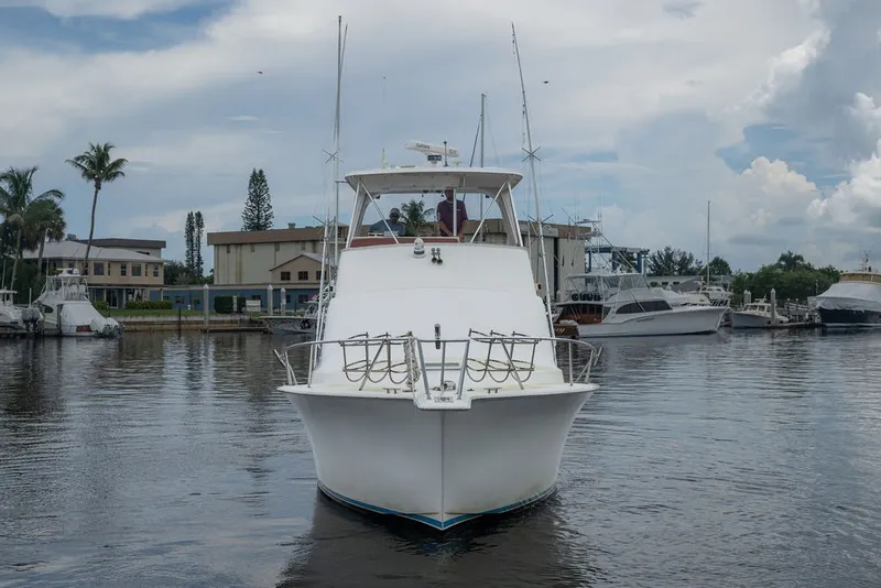Slide: The Image of 1997 Ocean Yachts 40 Super Sport docked at a marina, surrounded by other boats. - 15
