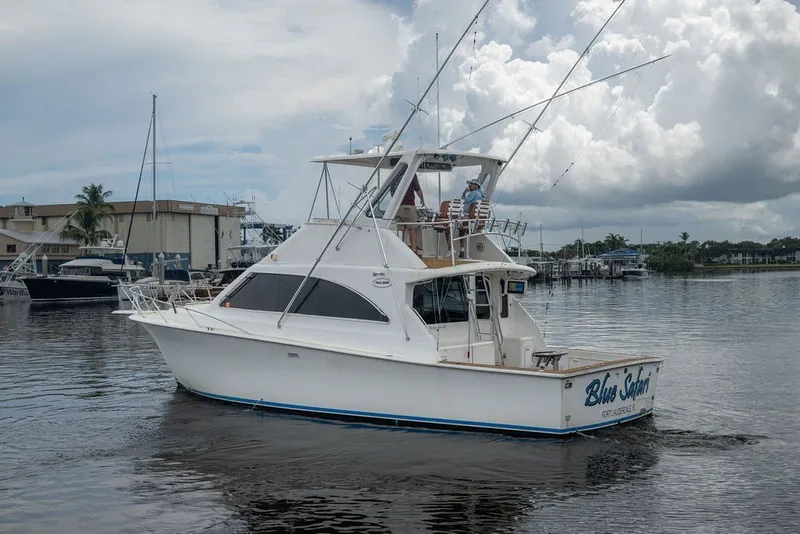 Slide: The Image of 1997 Ocean Yachts 40 Super Sport cruising on a calm waterway under cloudy skies. - 3